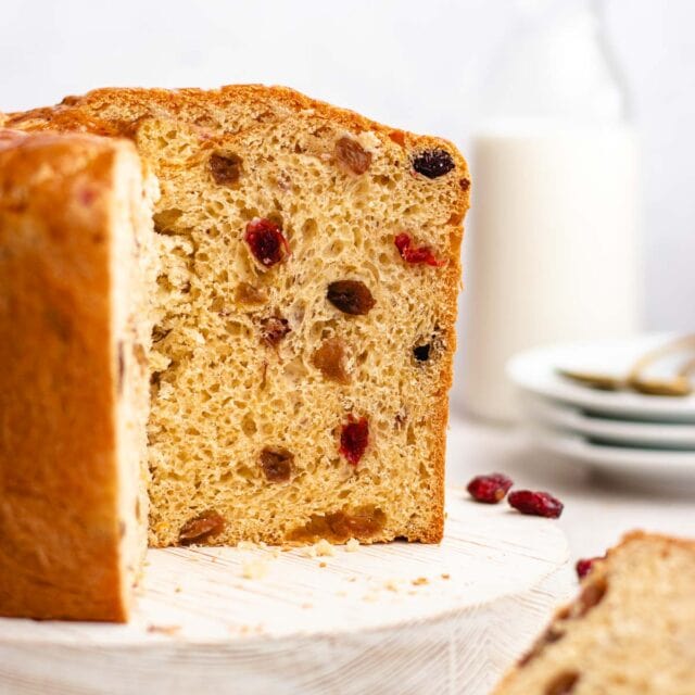 Panettone baked loaf with slice removed, side view 1x1