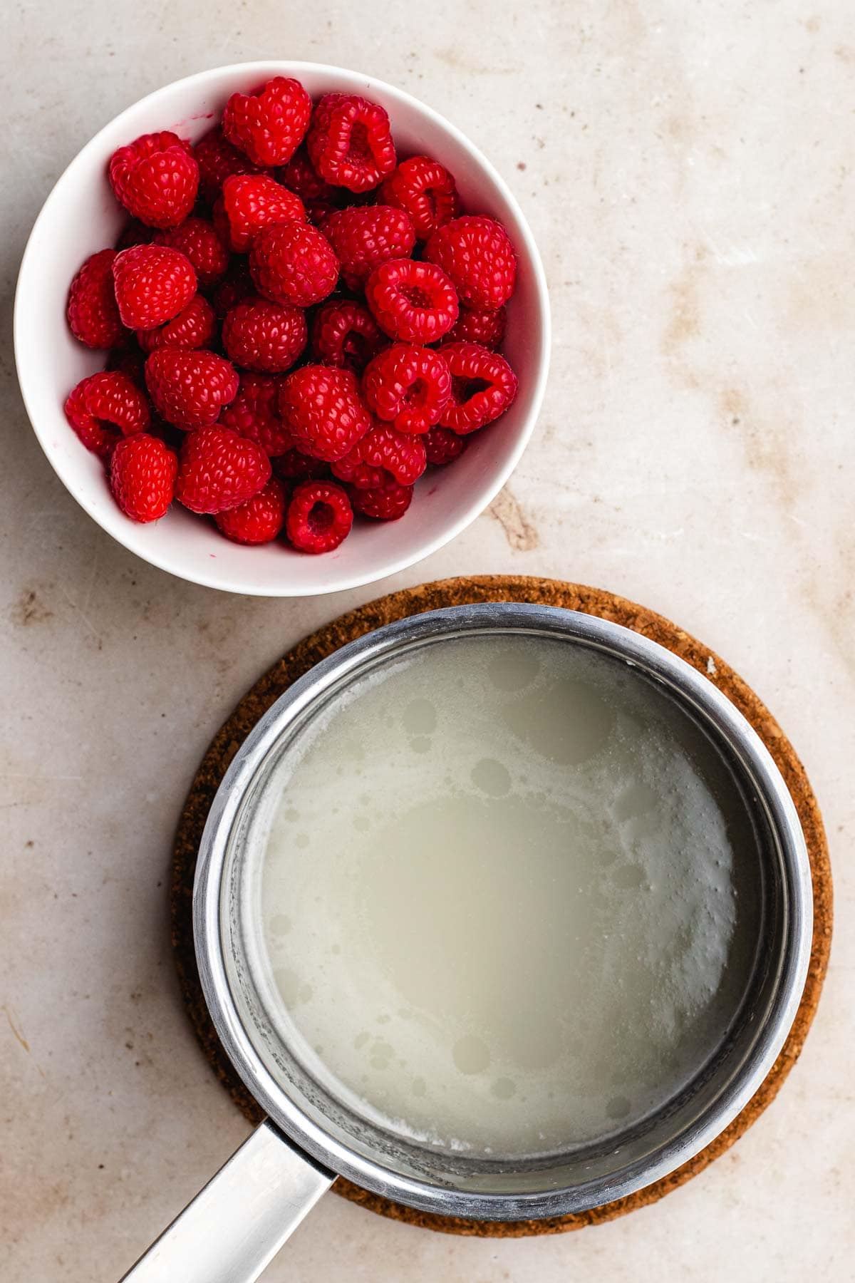 Raspberry Sauce sugar melting in pan and berries in bowl