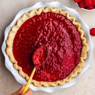 Raspberry Sauce spread on pie with spoon, 1x1
