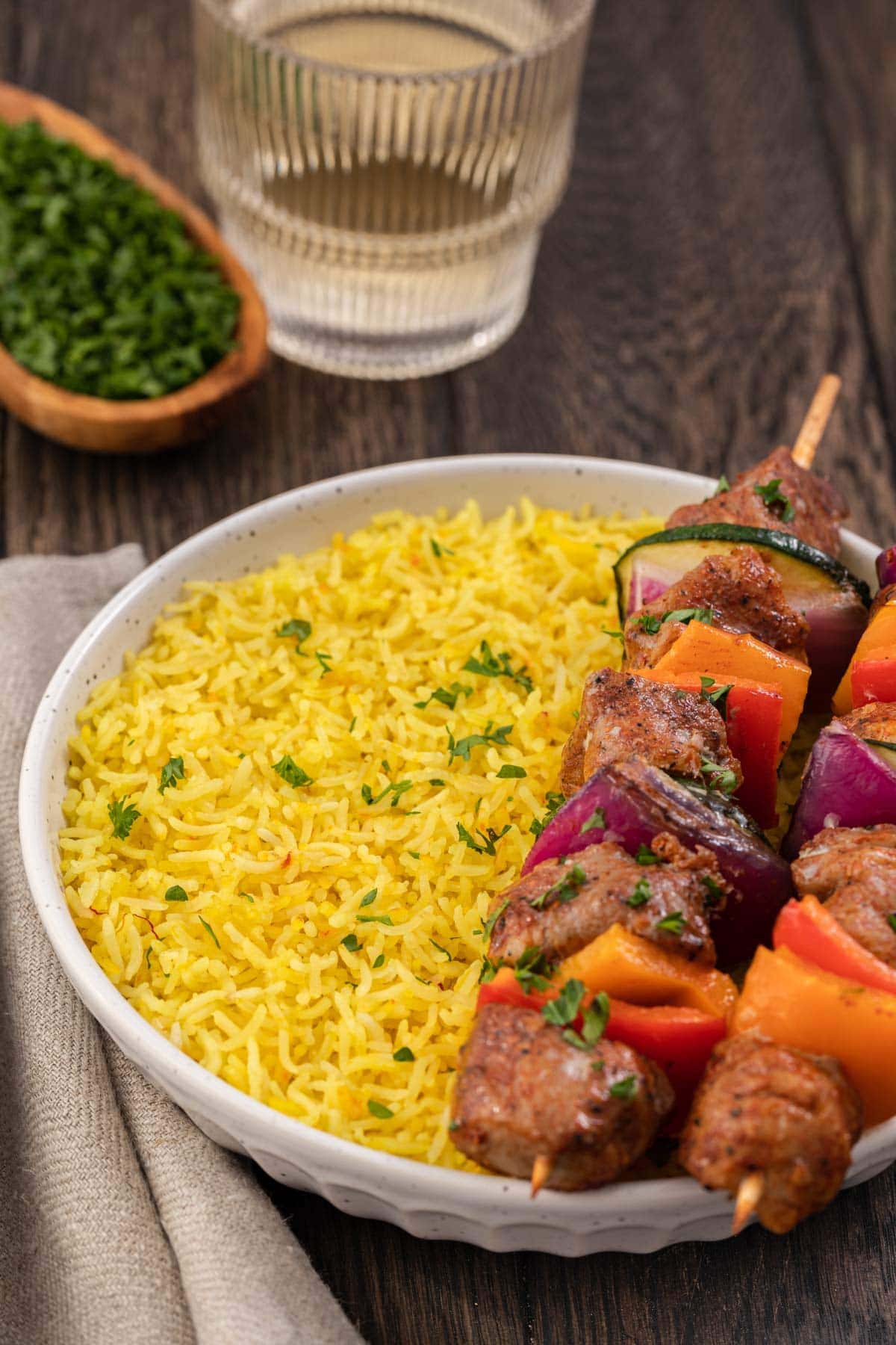 bowl of rice with kebobs 