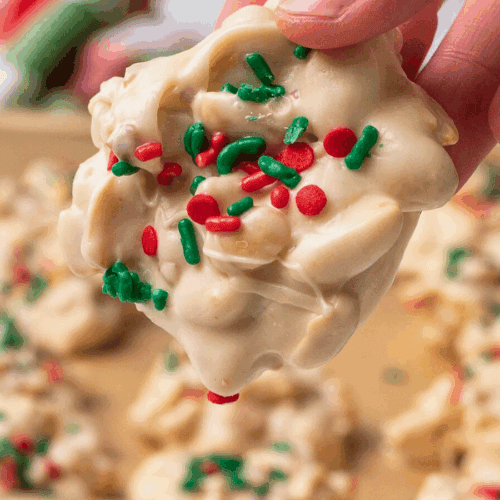 clusters of peanuts covered in vanilla creamy confections with somebody holding it