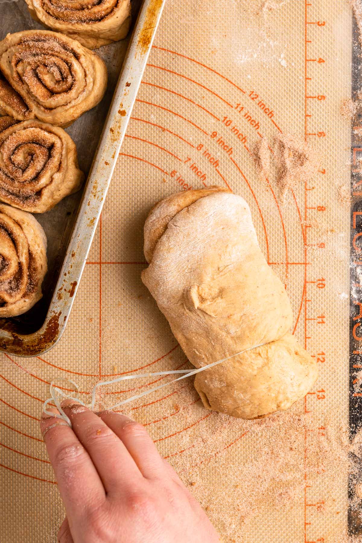 Sweet Potato Cinnamon Rolls cutting rolled dough log with thread