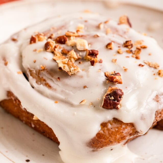 spiced spiral pastry with icing on a plate