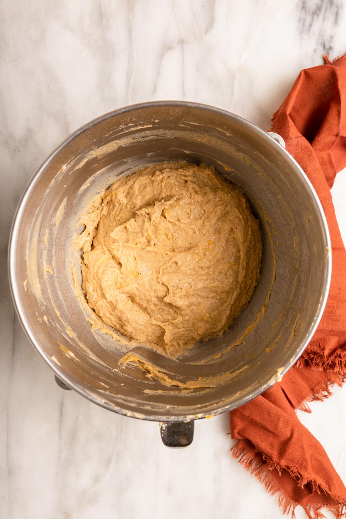 Sweet Potato Cinnamon Rolls dough in bowl before adding remaining dry ingredients.