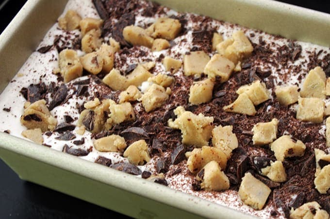 ice cream in a pan with cookie dough crumbles for Ultimate Cookie Dough Ice Cream Sandwich
