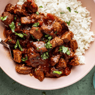 close up of meat and rice in a bowl