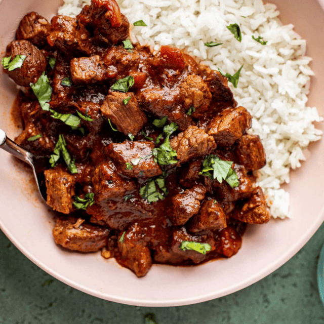 close up of meat and rice in a bowl