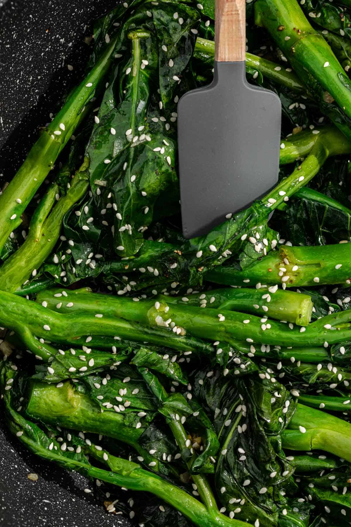 moving broccoli around with a spatula 