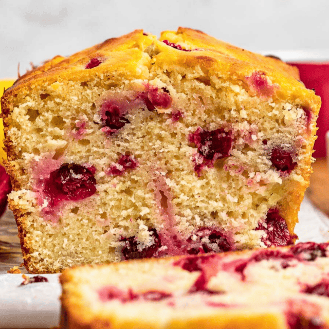a slice of citrus tart loaf with one laying in front