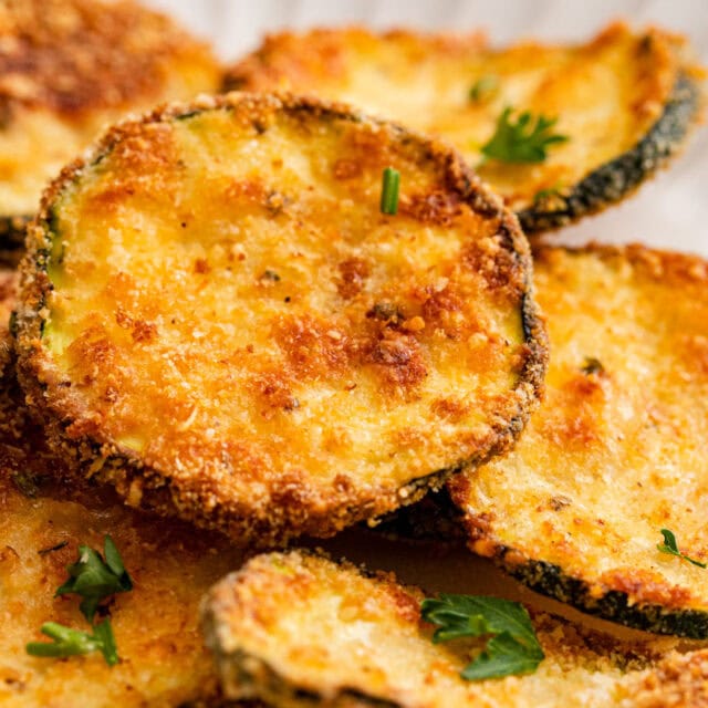 Breaded zucchini on serving plate.