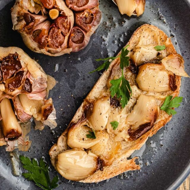 Roasted cloves of garlic on bread.