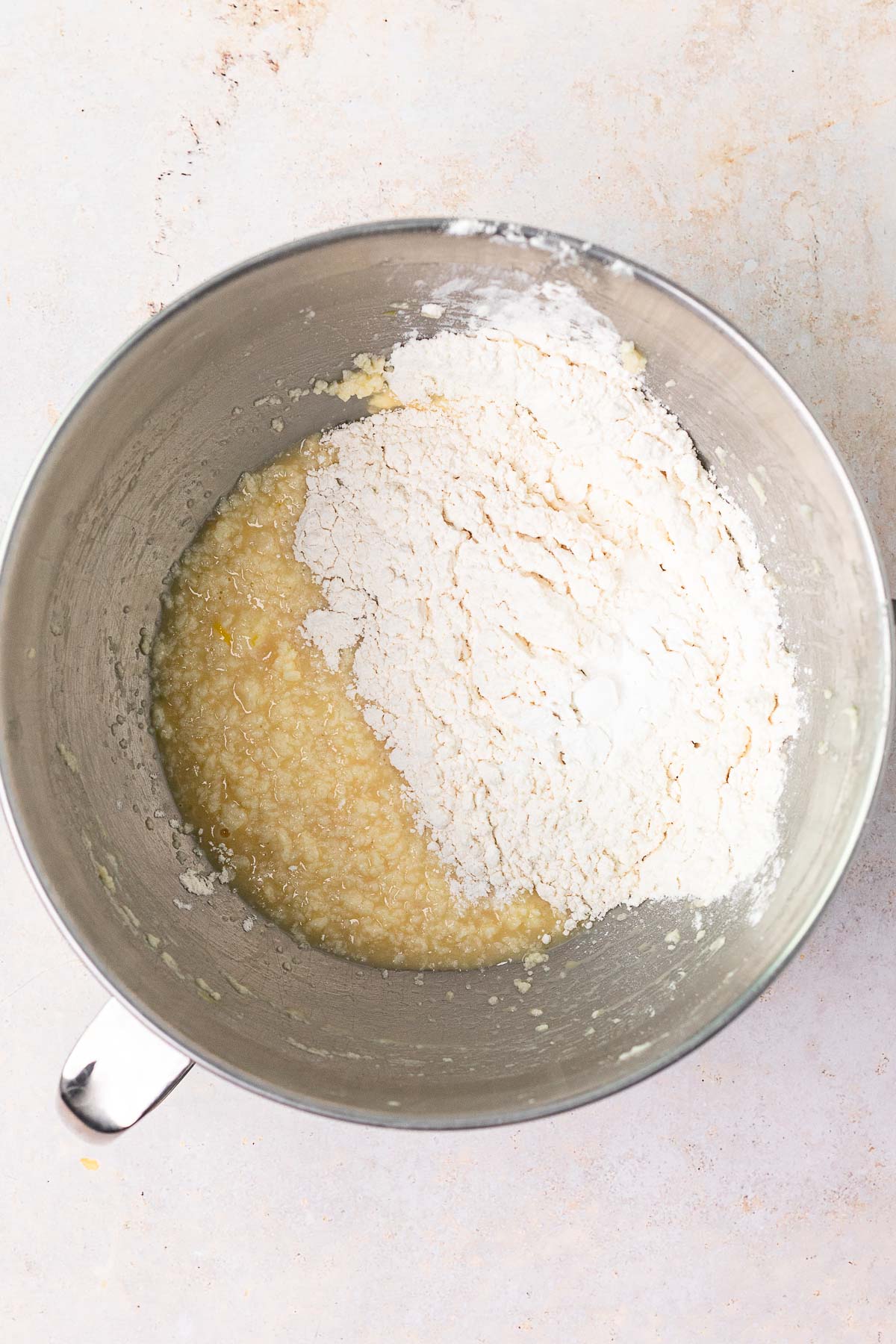 Slow Cooker Spumoni Cake adding dry batter ingredients to wet ingredients in mixing bowl