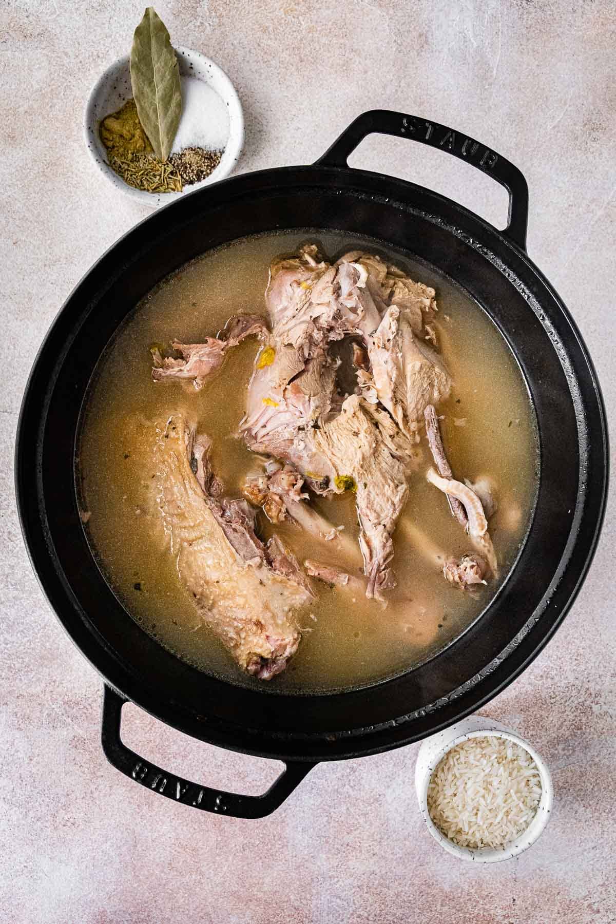 Turkey Carcass Soup broth and carcass in soup pot after cooking