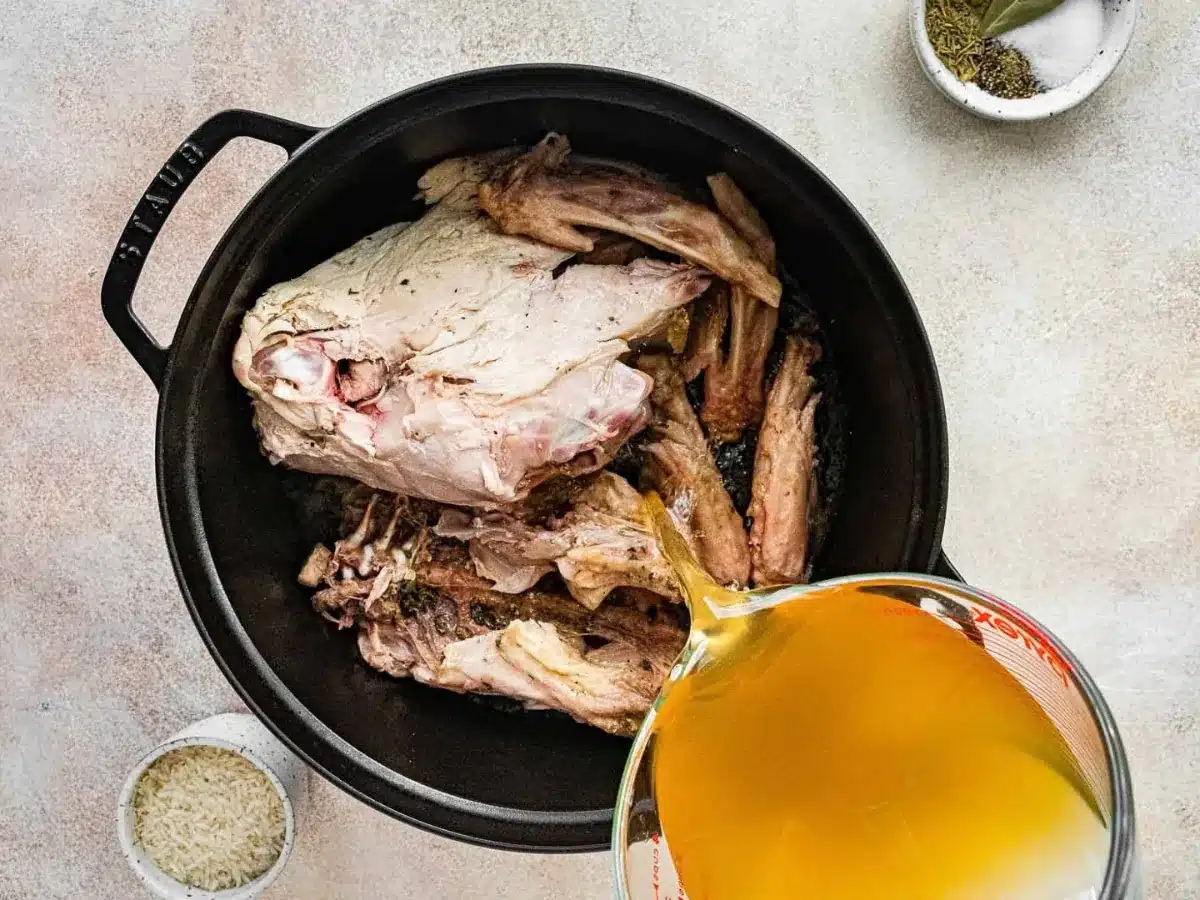 Turkey in pot with broth poured over it