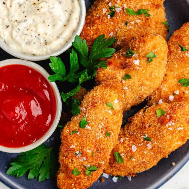 Dinner plate with breaded chicken, and dipping sauces.