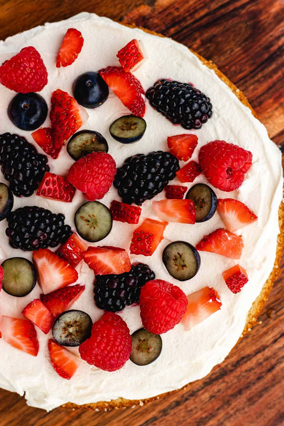 topping berries on a layer 