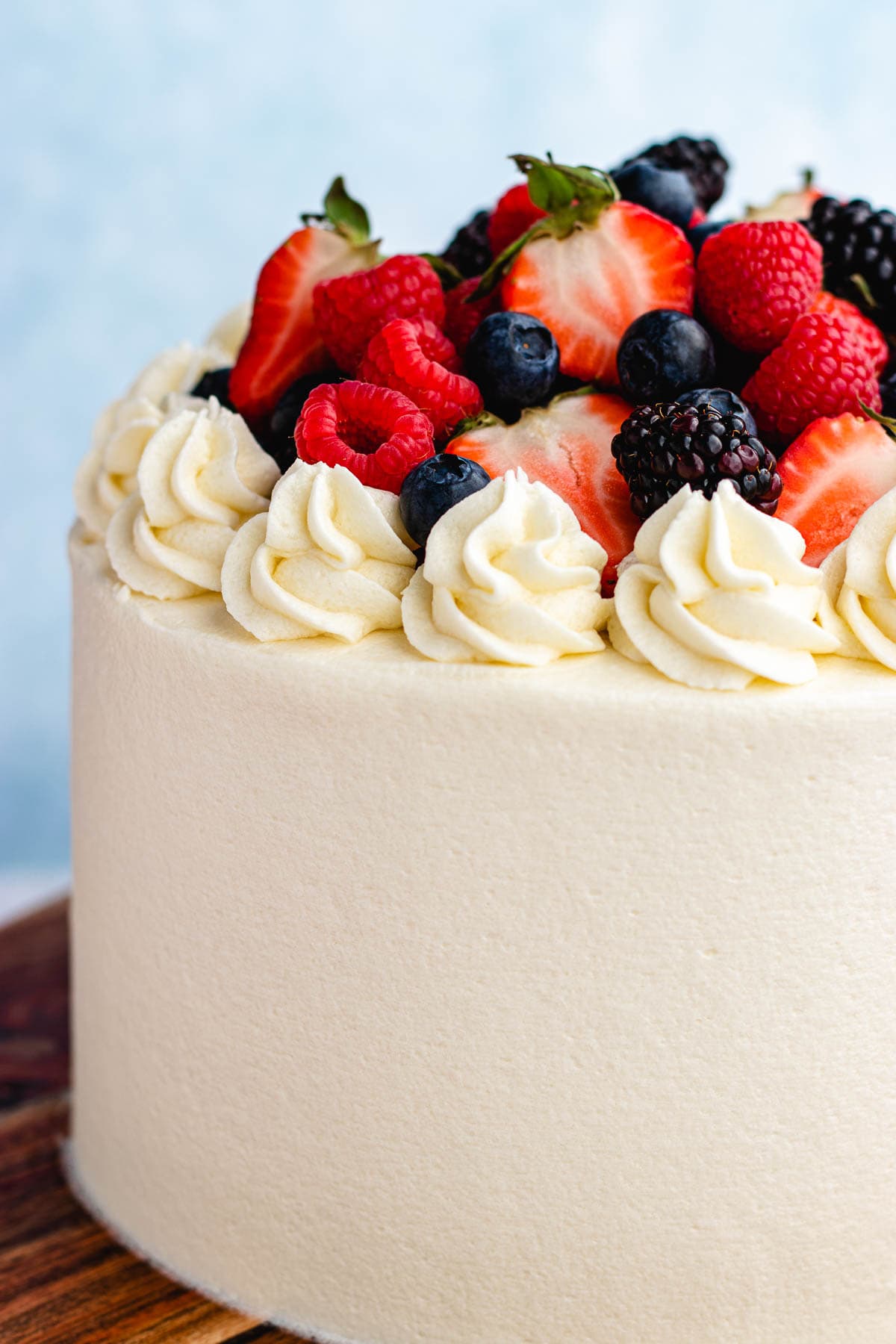 closeup of white cake with berries on top