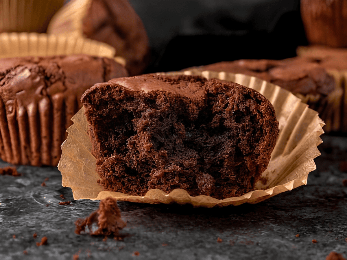 brown chewy dessert in a muffin liner bitten in half