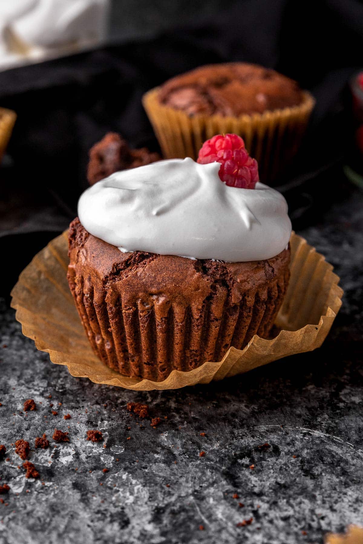 Crinkly Brownie Muffin with whipped cream and a raspberry