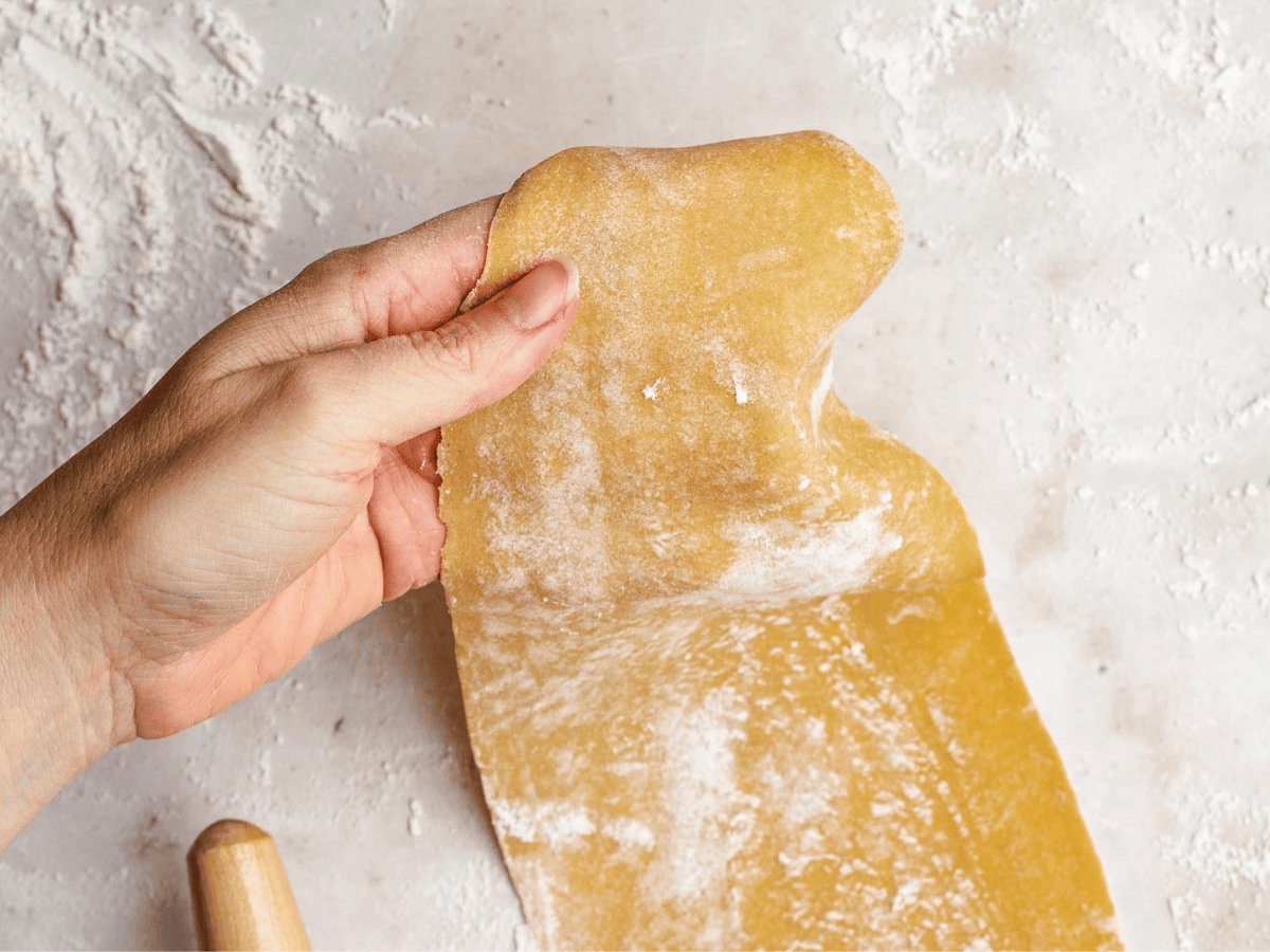 Pasta dough rolled out with rolling pin.