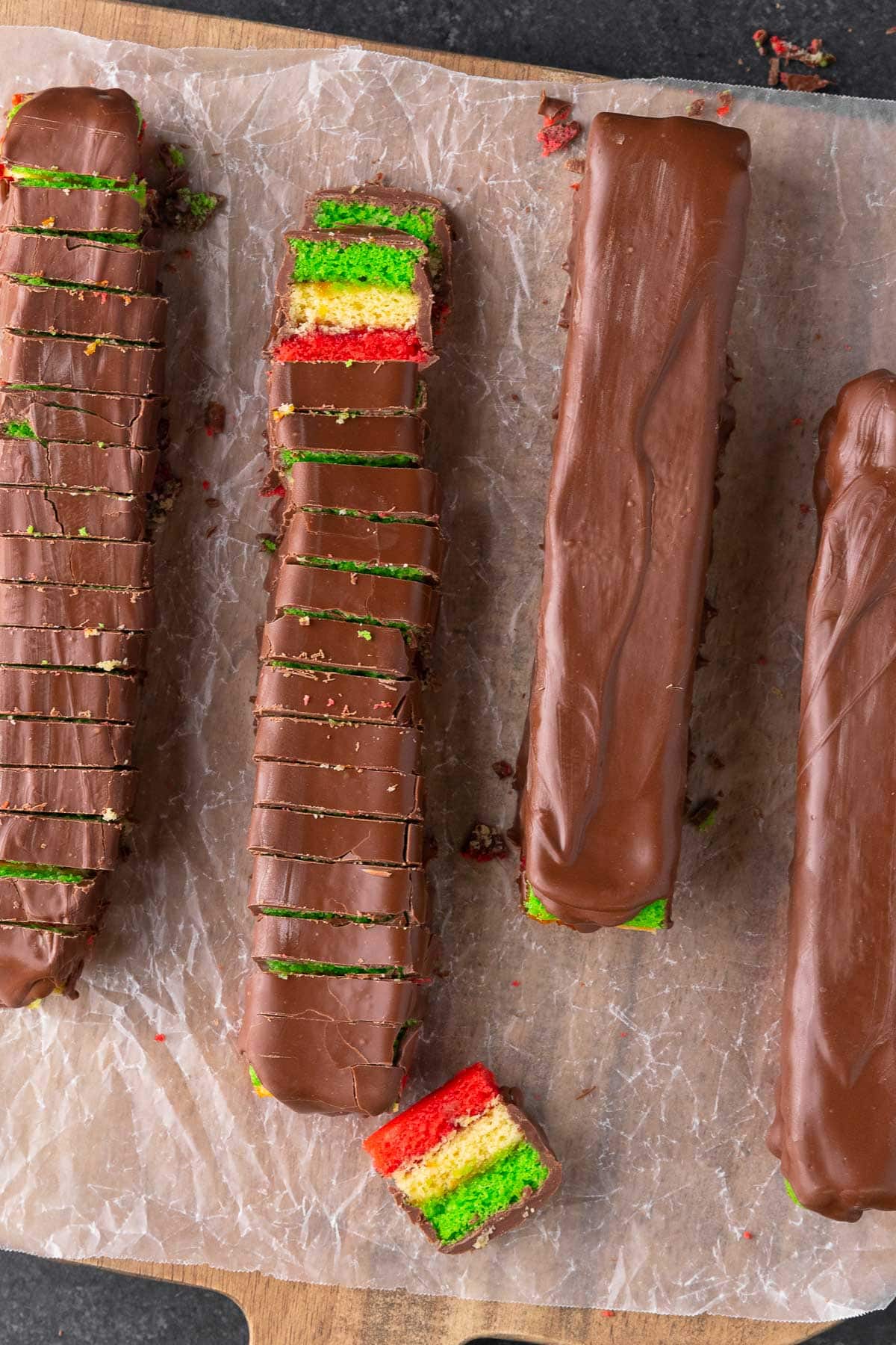 slicing cooled Italian Rainbow Cookies covered with melted chocolate