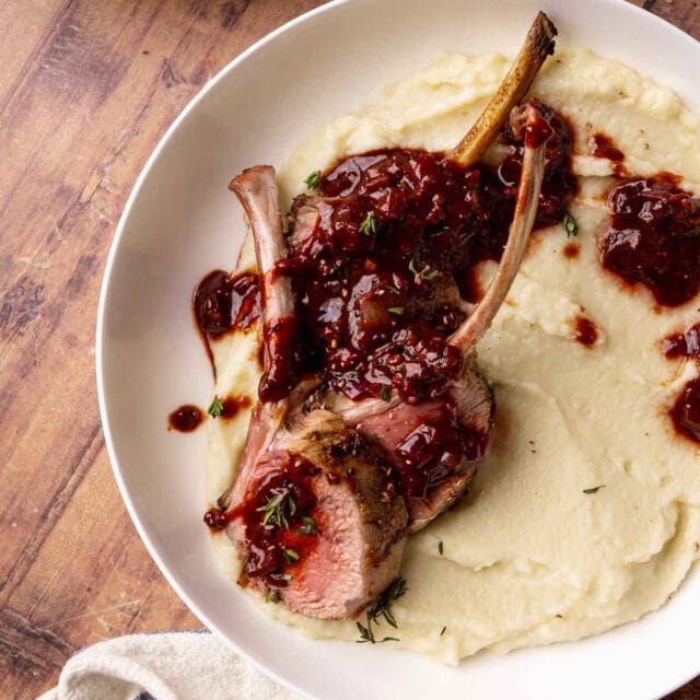 Lamb Chops cooked and plated over mashed potatoes, topped with red wine sauce, 1x1