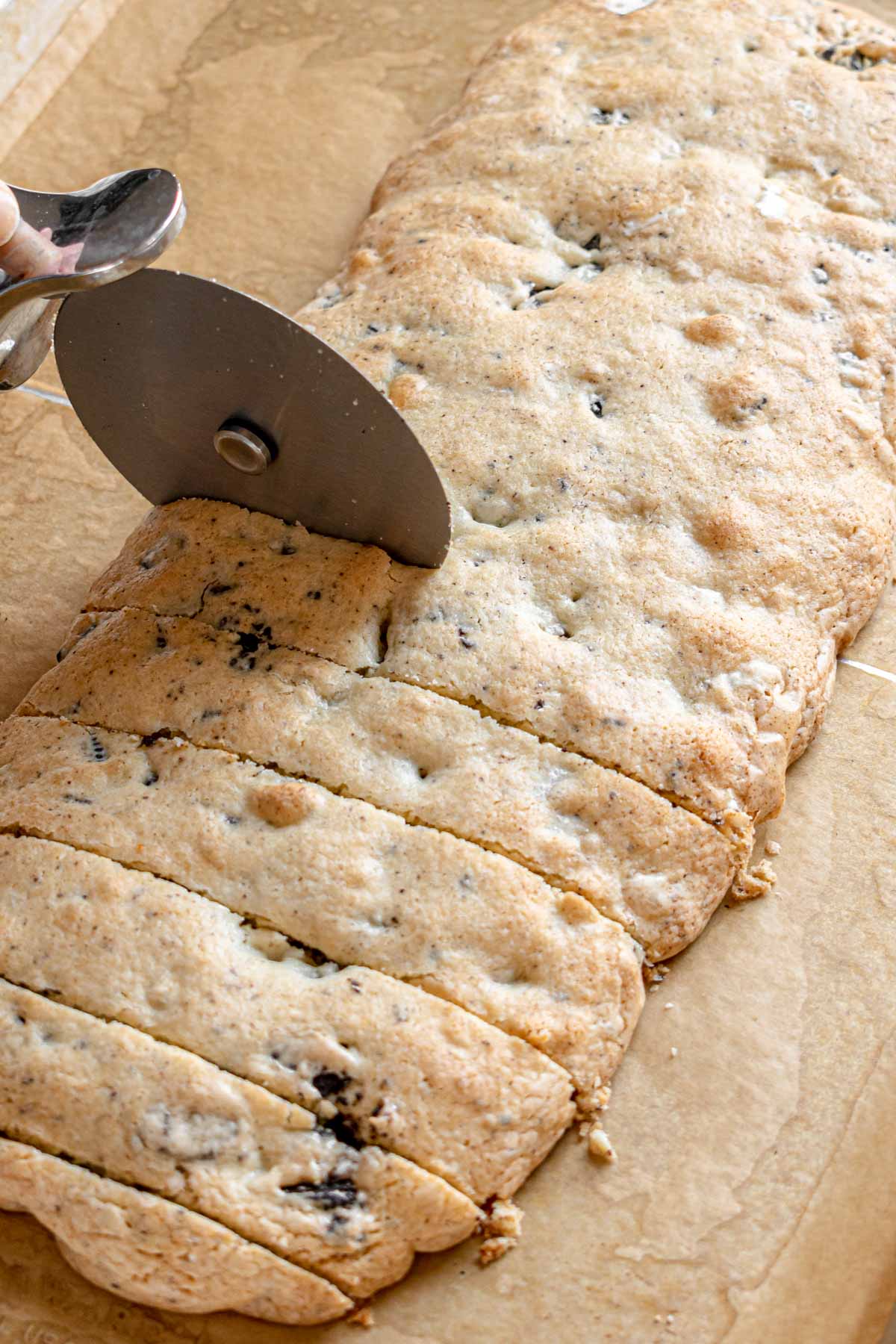 Oreo Dipped Biscotti cutting baked cookie dough log