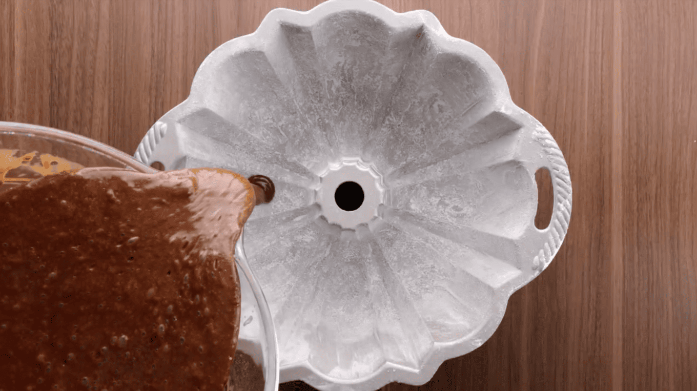 pouring chocolate batter into bundt cake pan
