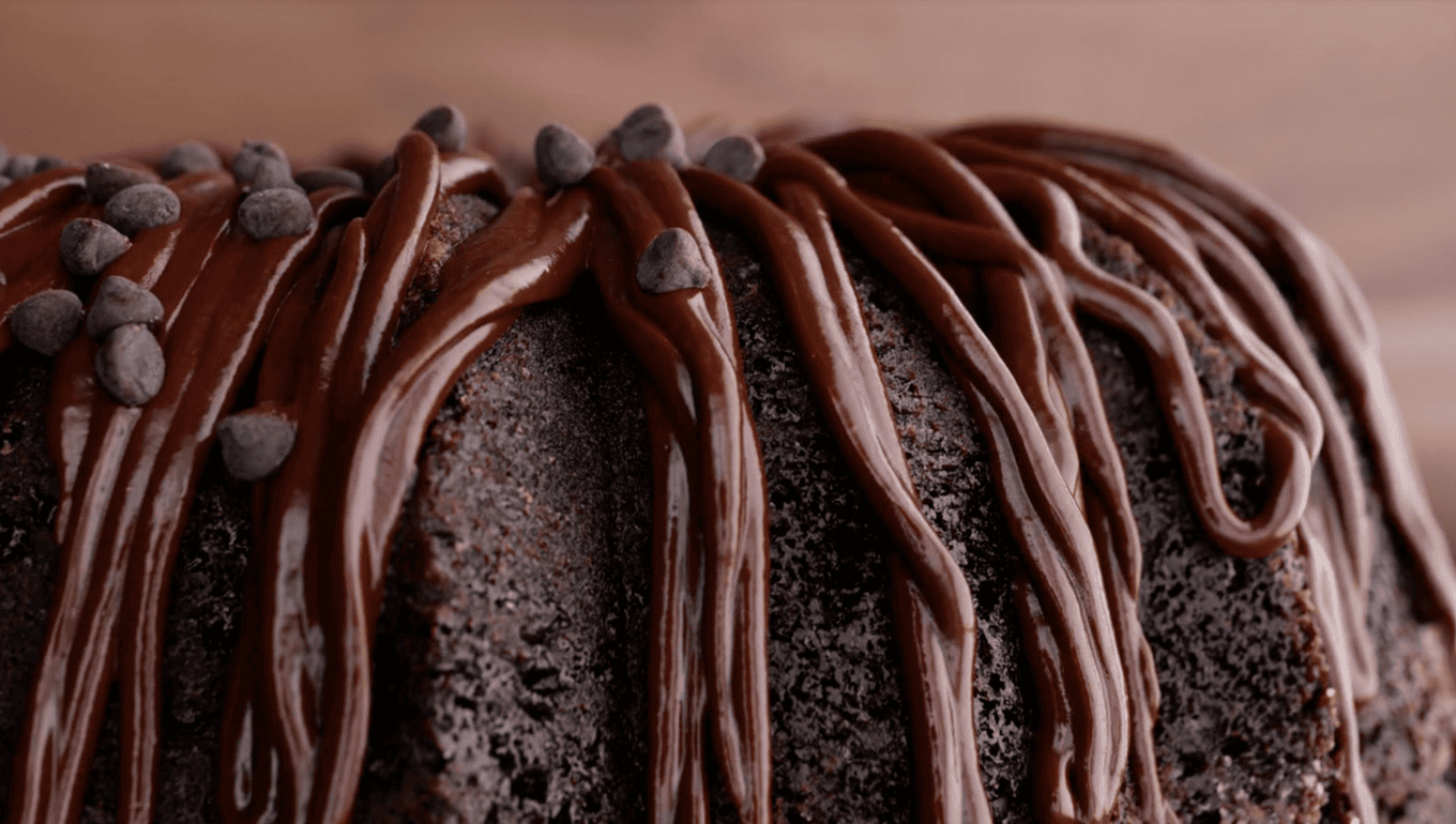 drizzling chocolate chips on chocolate bundt cake