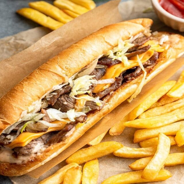 Sandwich on brown paper with french fries