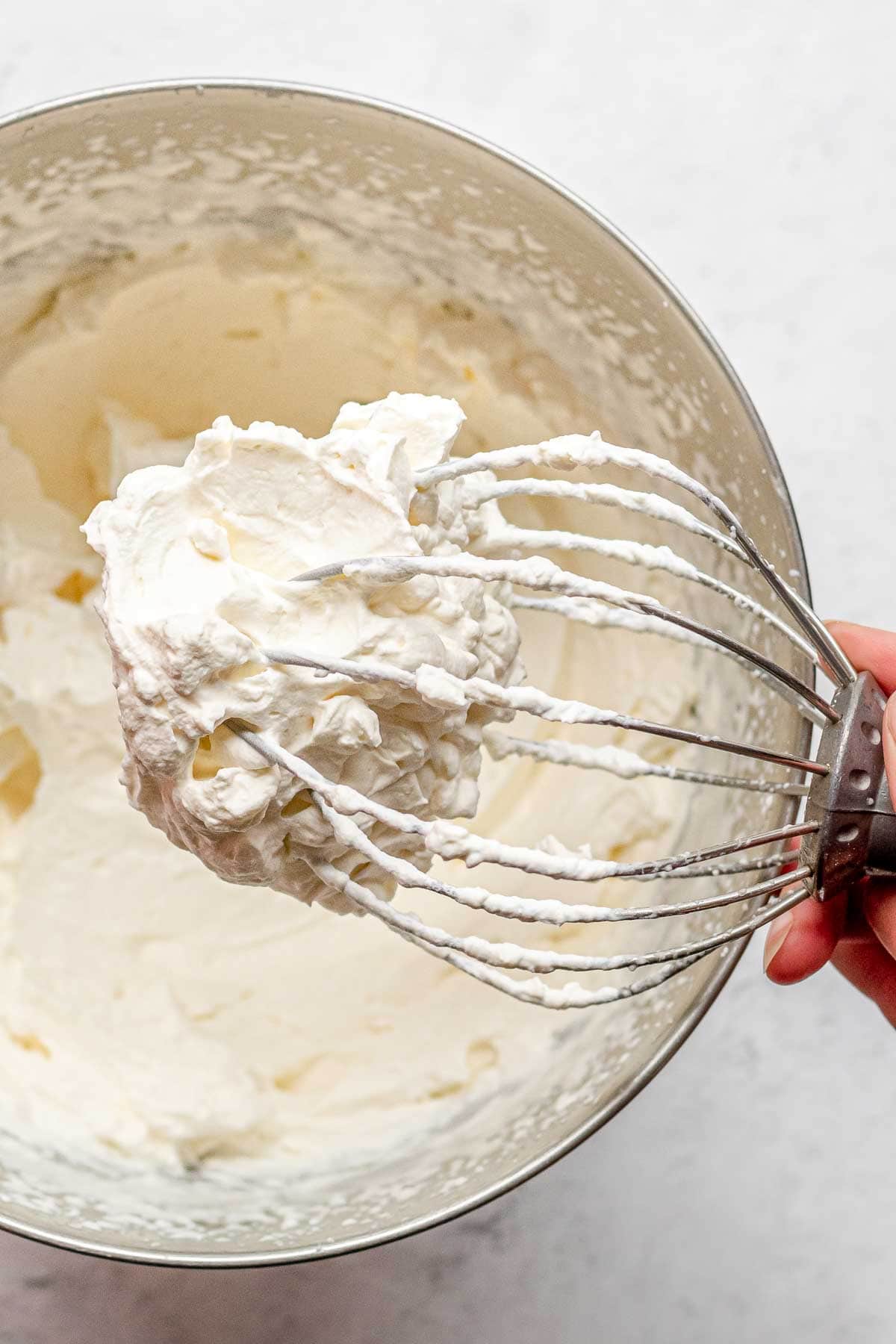 closeup of whipped cream on whisk