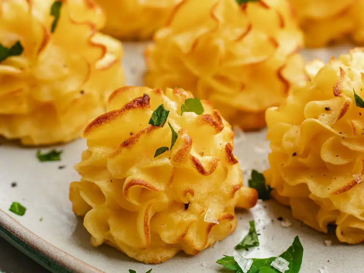 Piped potato bites on serving tray.