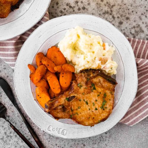 Air Fryer Garlic Butter Pork Chops on a plate with sidees