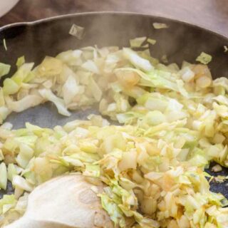 Cabbage frying in pan.