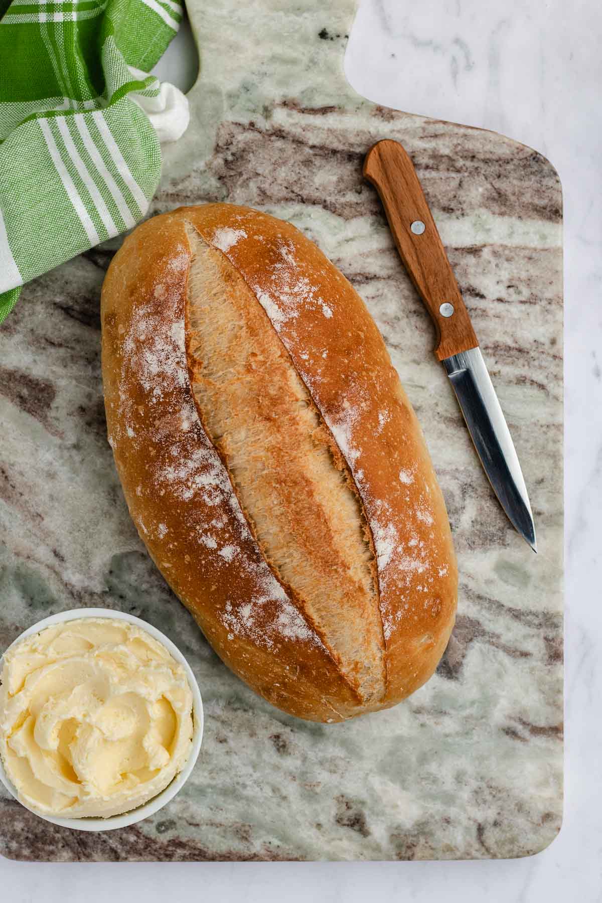 cooked Italian Bread with knife and butter from above