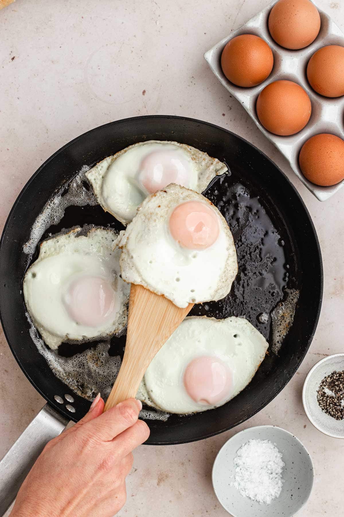 Over Easy Eggs in the pan being flipped