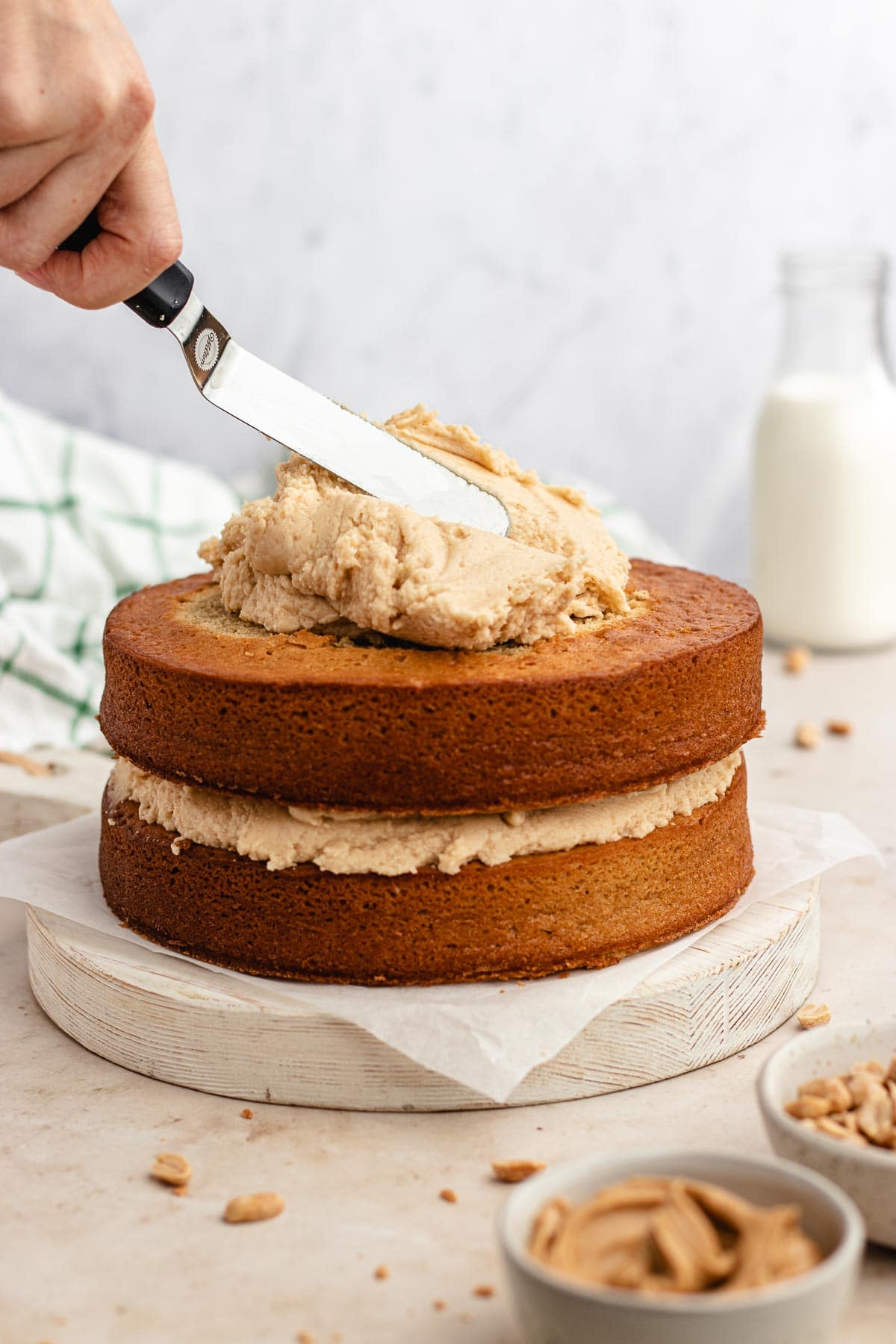Peanut Butter Layer Cake being frosted
