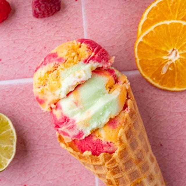 Sherbet in cone laying on pink counter