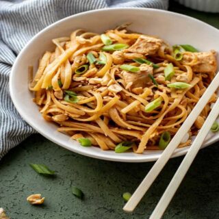 White bowl of Chicken Noodles with chopsticks