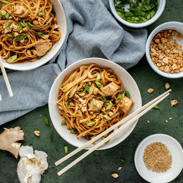 noodles and chicken in bowls with chopsticks
