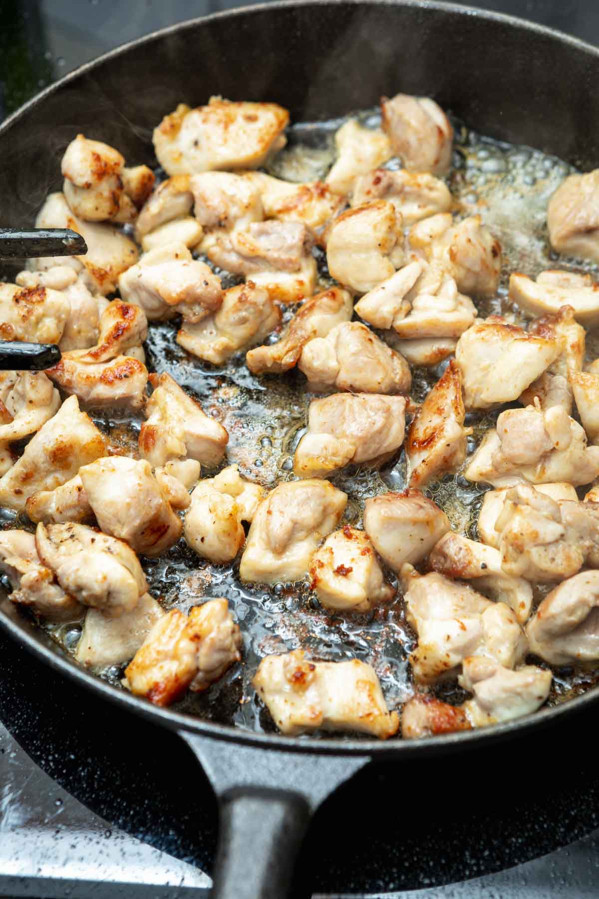 cooking diced chicken in skillet