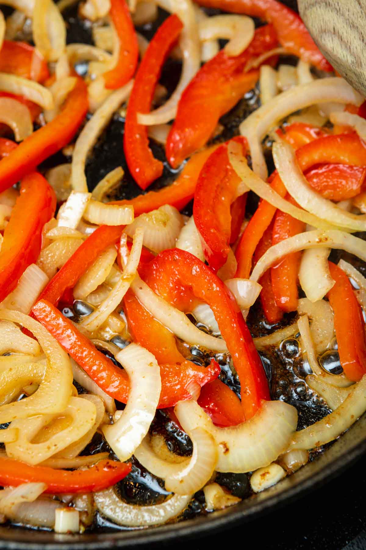 bell peppers and onions frying in skillet