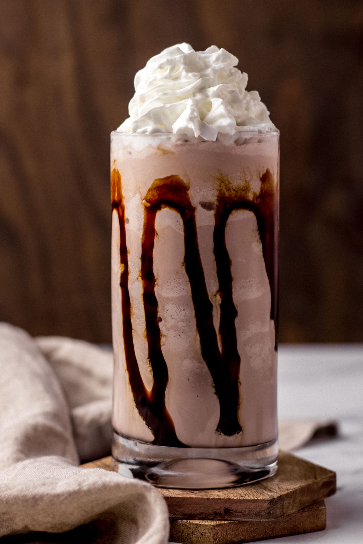 TGI Fridays Mudslide finished milkshake in glass with chocolate syrup in glass and whipped cream on top