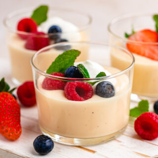 Vanilla Pudding finished in small glass cup with berries and mint garnish, 16x9