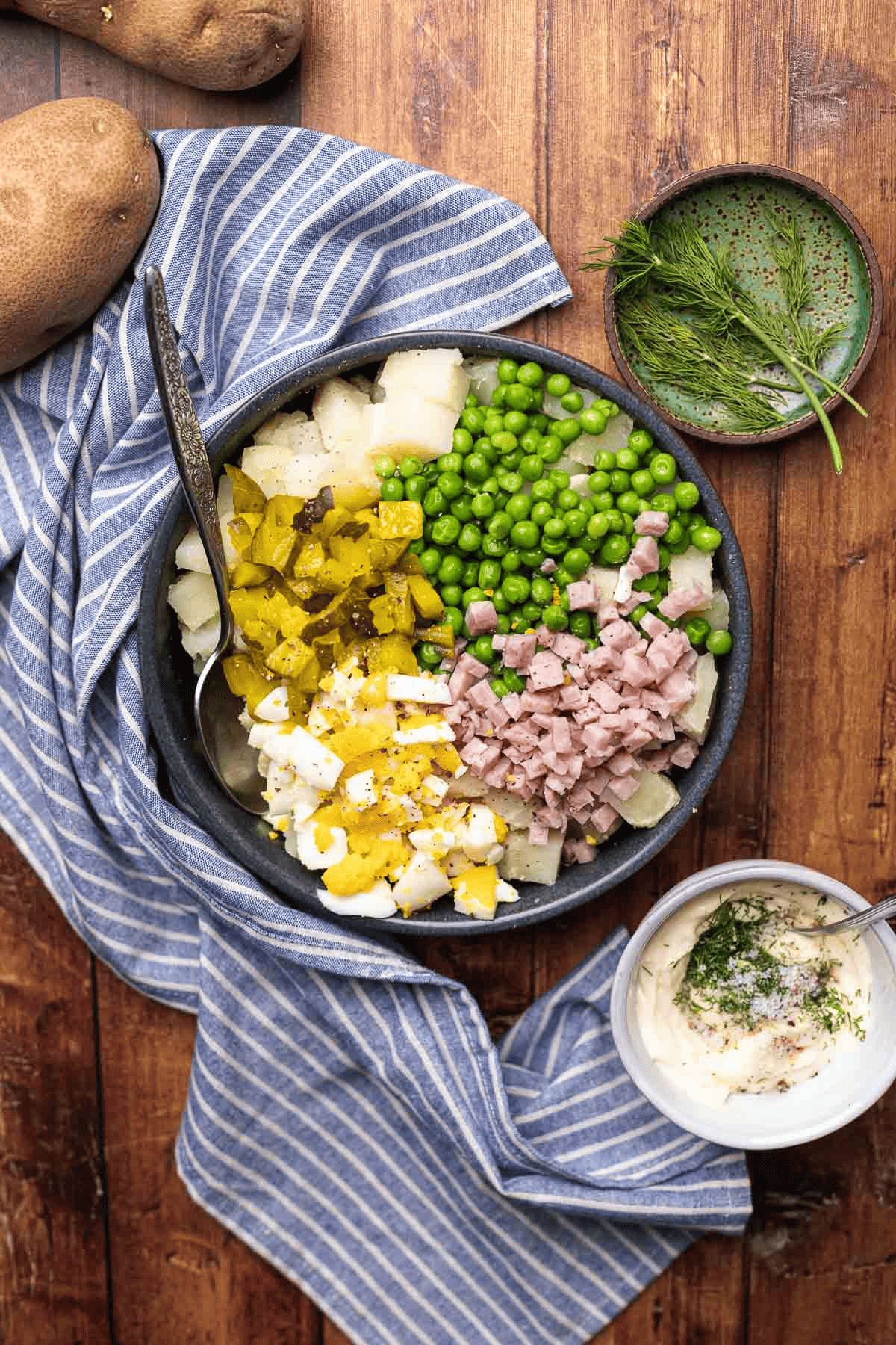 Unmixed salad ingredients and unmixed dressing in a separate bowl