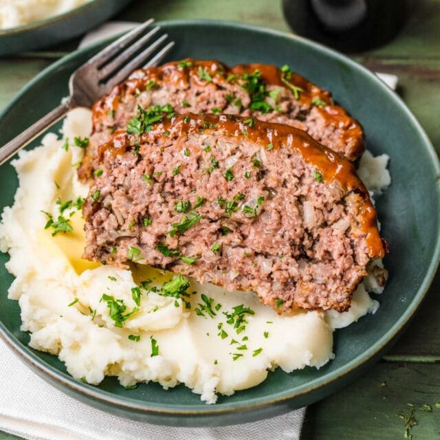square pic of two slices of meatloaf on a bed of mashed potatoes
