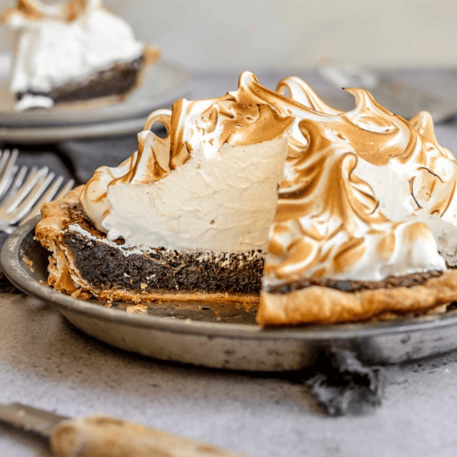 View of pie in tin with slice taken out