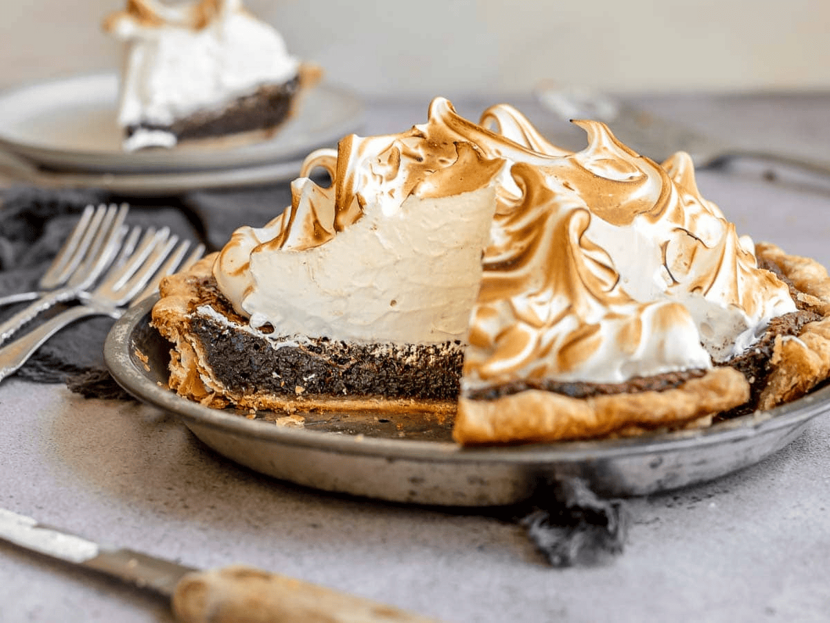 View of pie in tin with slice taken out