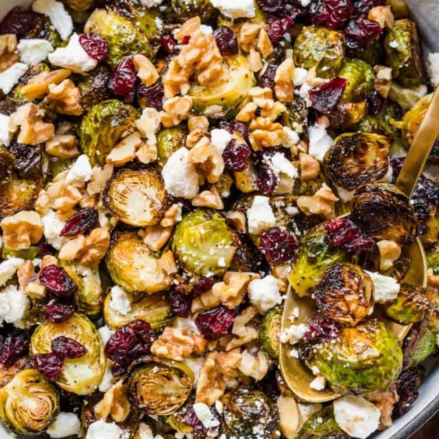 Finished Brussels sprouts in a serving bowl with spoon