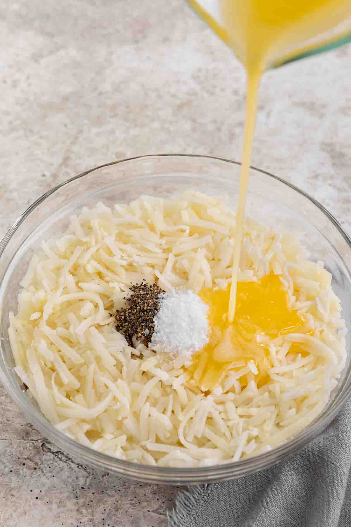 pouring egg into hash